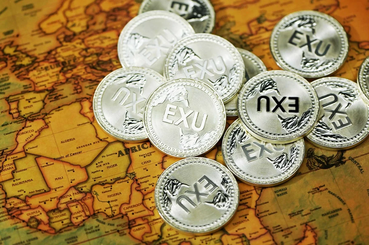 best Amex Platinum travel benefits - A variety of Executium coins on top of a maps