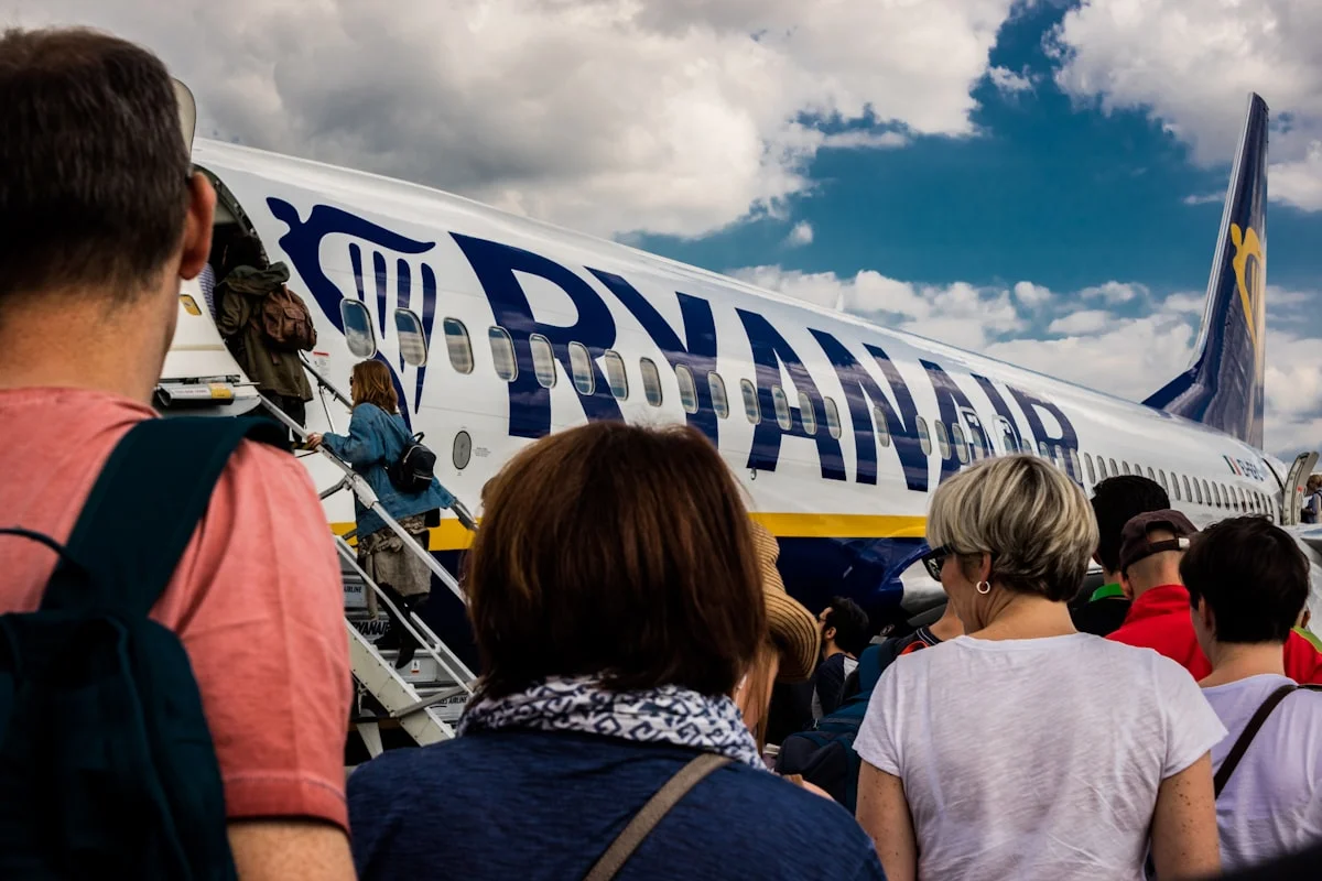 best first-class flights to Europe deals - passengers entering a Ryanair aeroplane