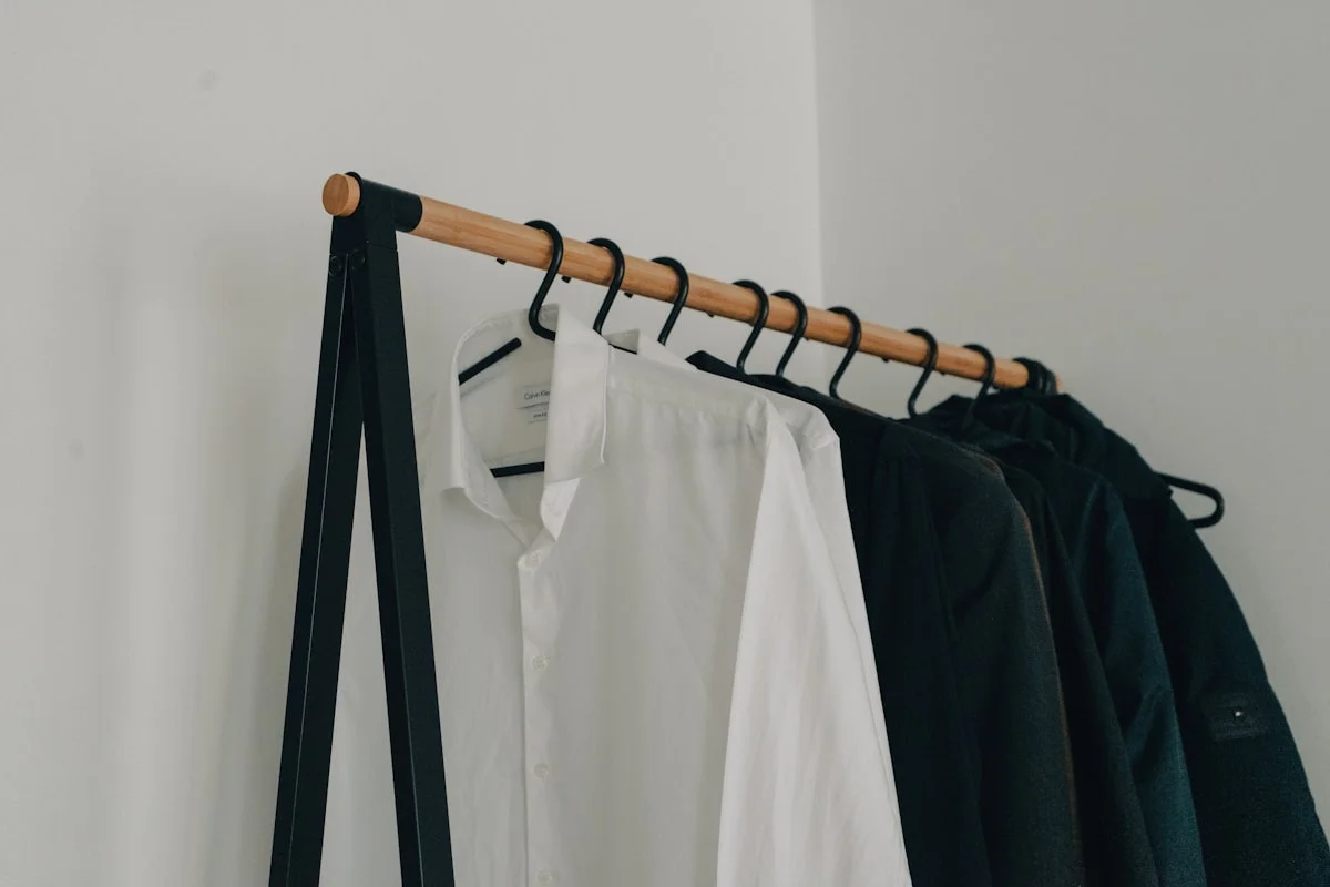 minimalist wardrobe essentials checklist - shirts hanging on clothes stand