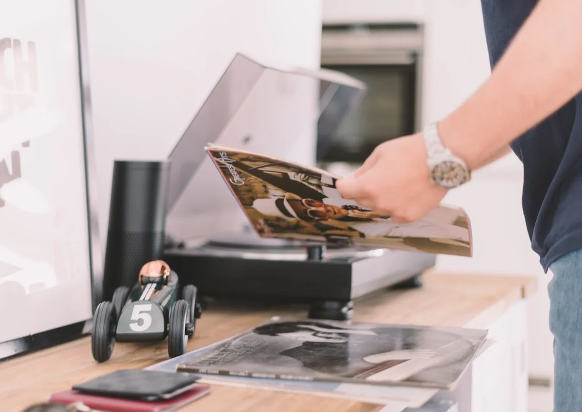 how to start a print-on-demand business with no money USA - Man reading vinyl record